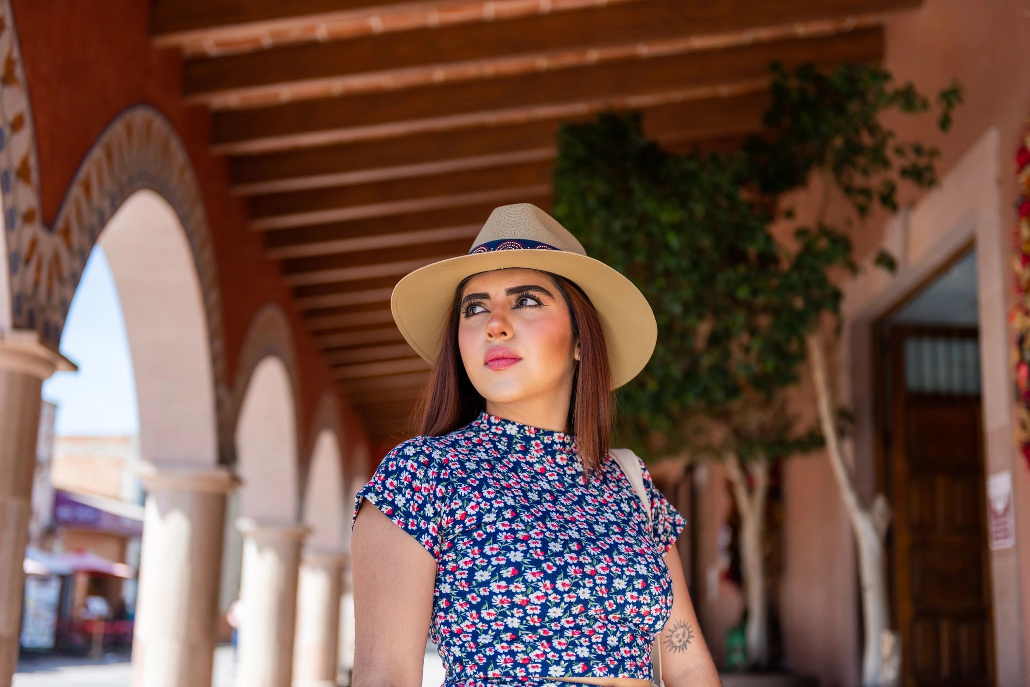 Young woman wearing a stylish hat while traveling