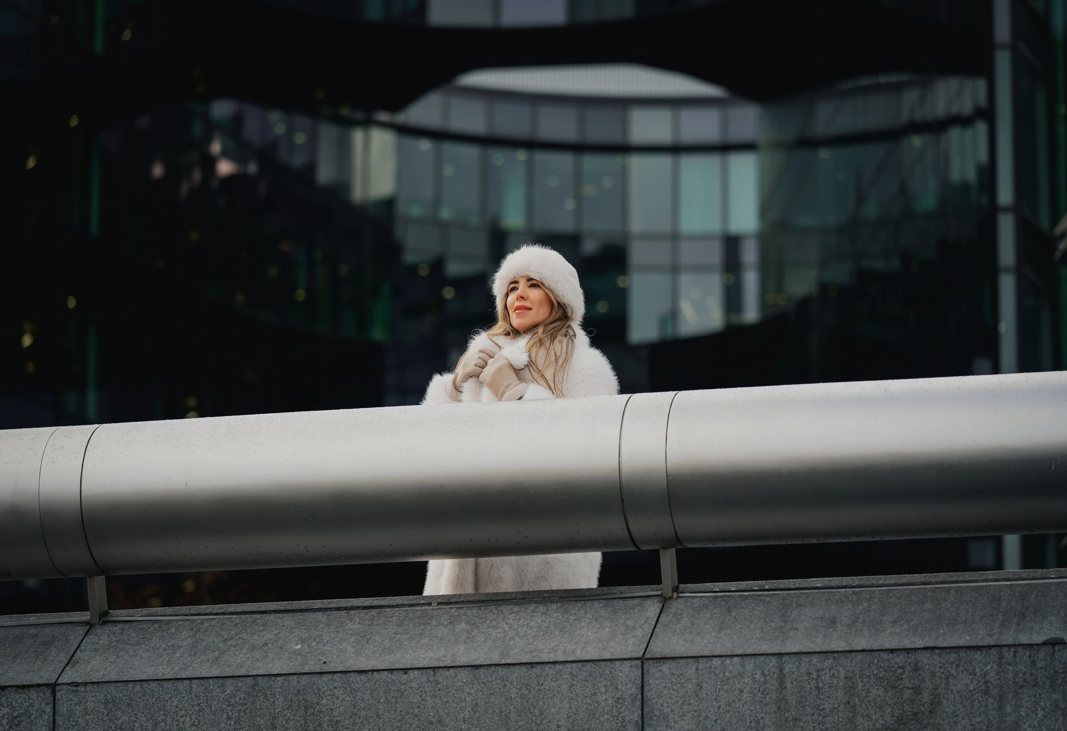 Woman wearing a stylish white fur hat in a modern fashion setting